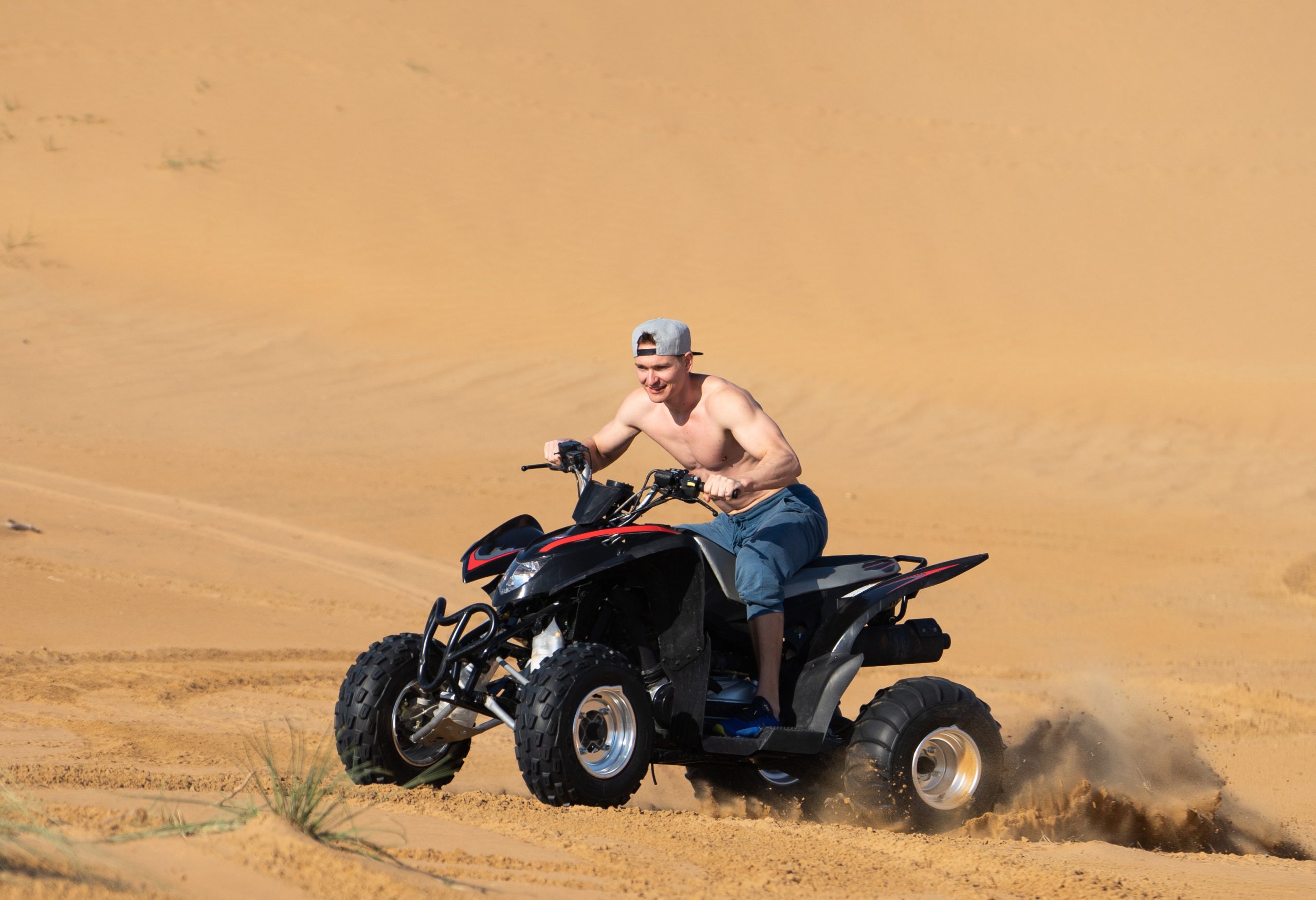 Rider on a quad bike in the desert near Dubai